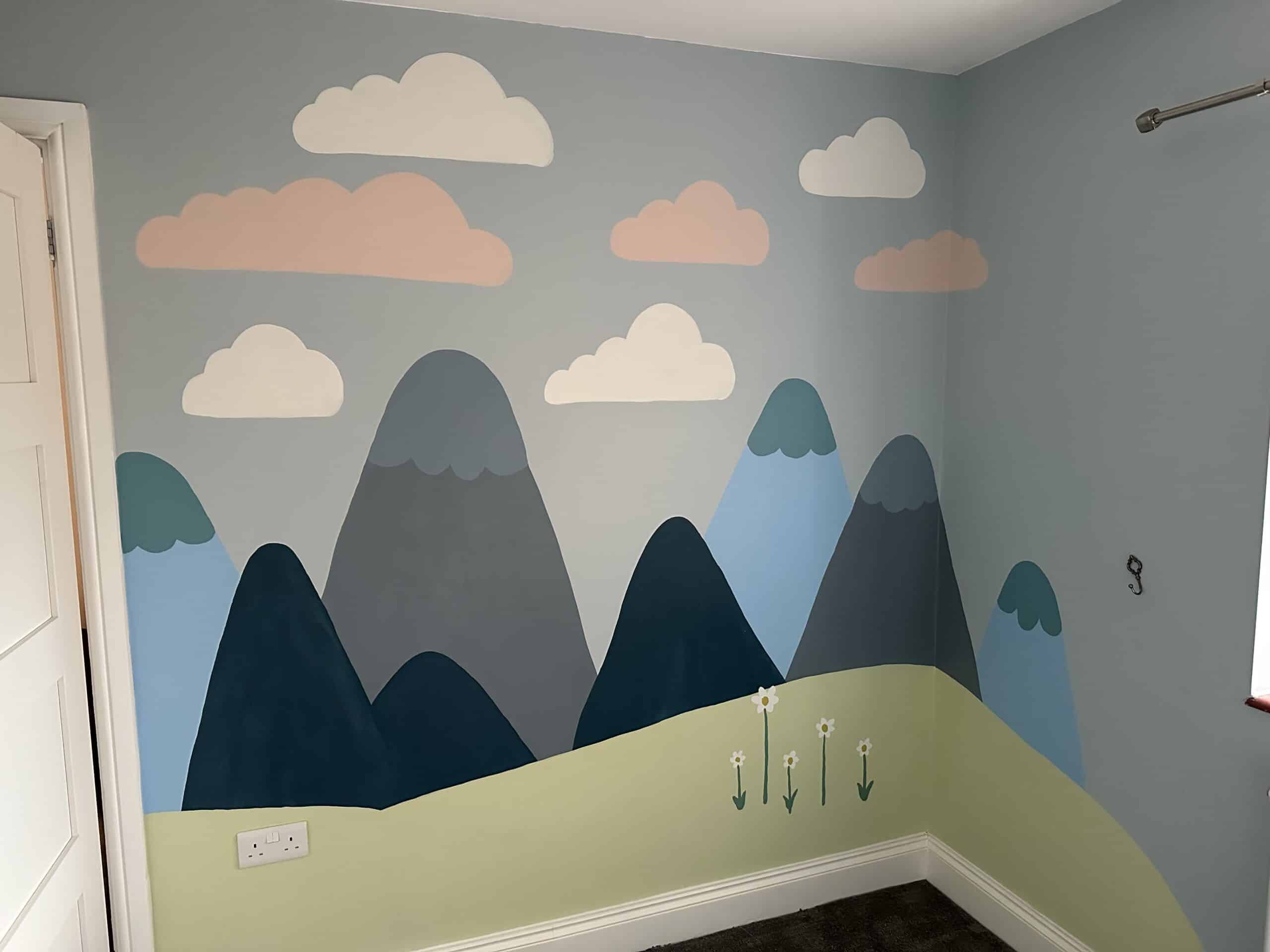 Colorful mountain and cloud mural in a creative space.