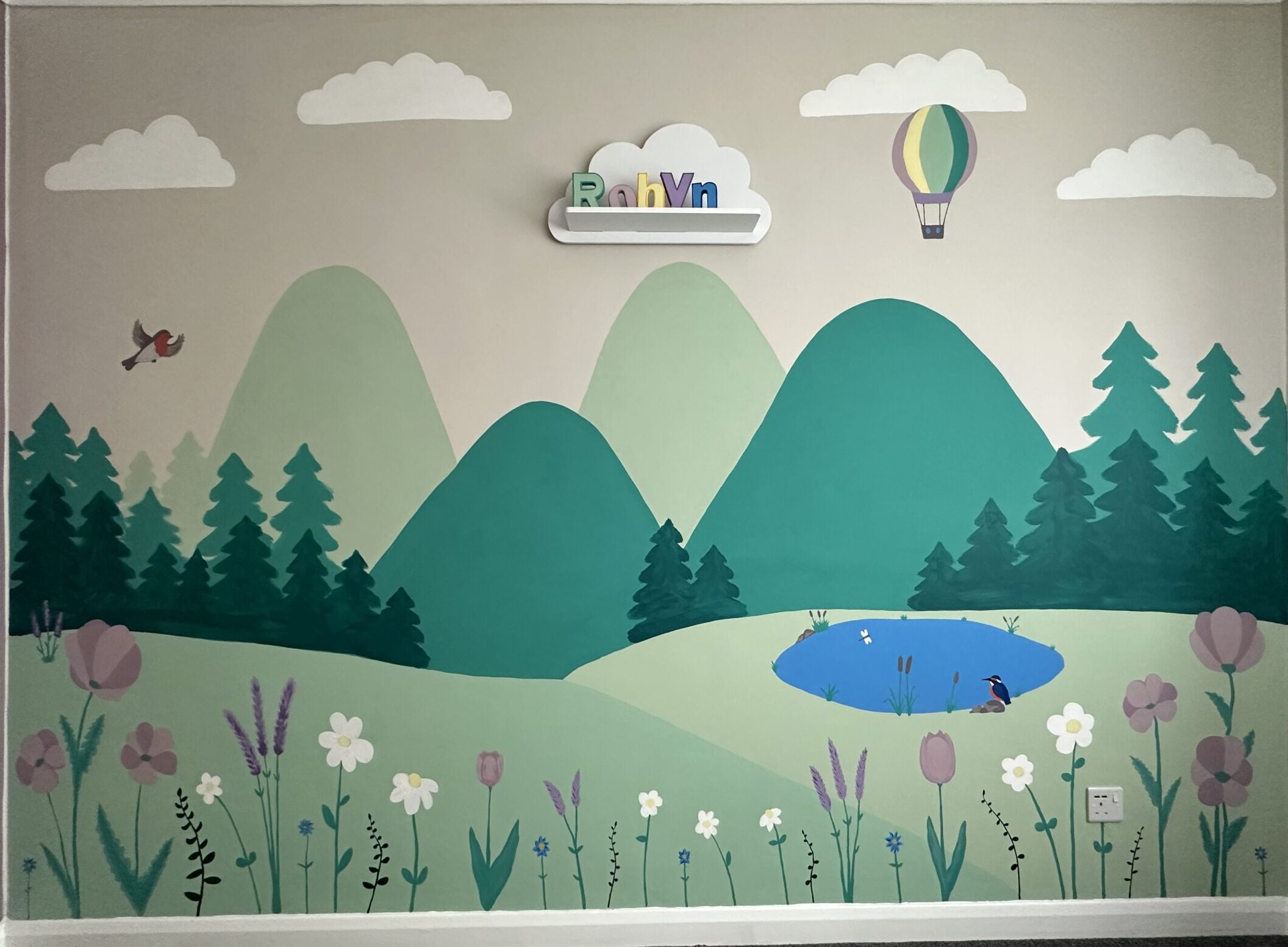 Colorful mountain and nature mural in a creative space.